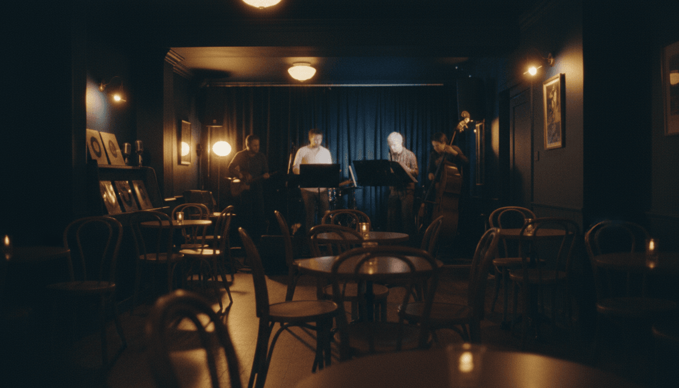 intimate jazz club interior with warm gold and navy ambient lighting, small stage area with silhouetted figures