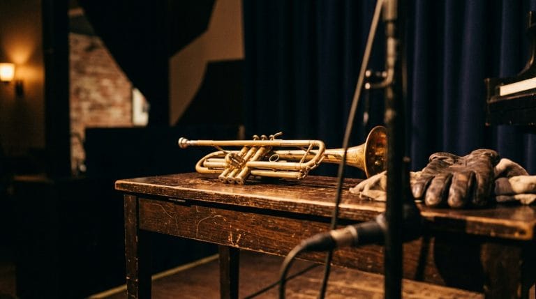 trumpet on piano bench in warm light